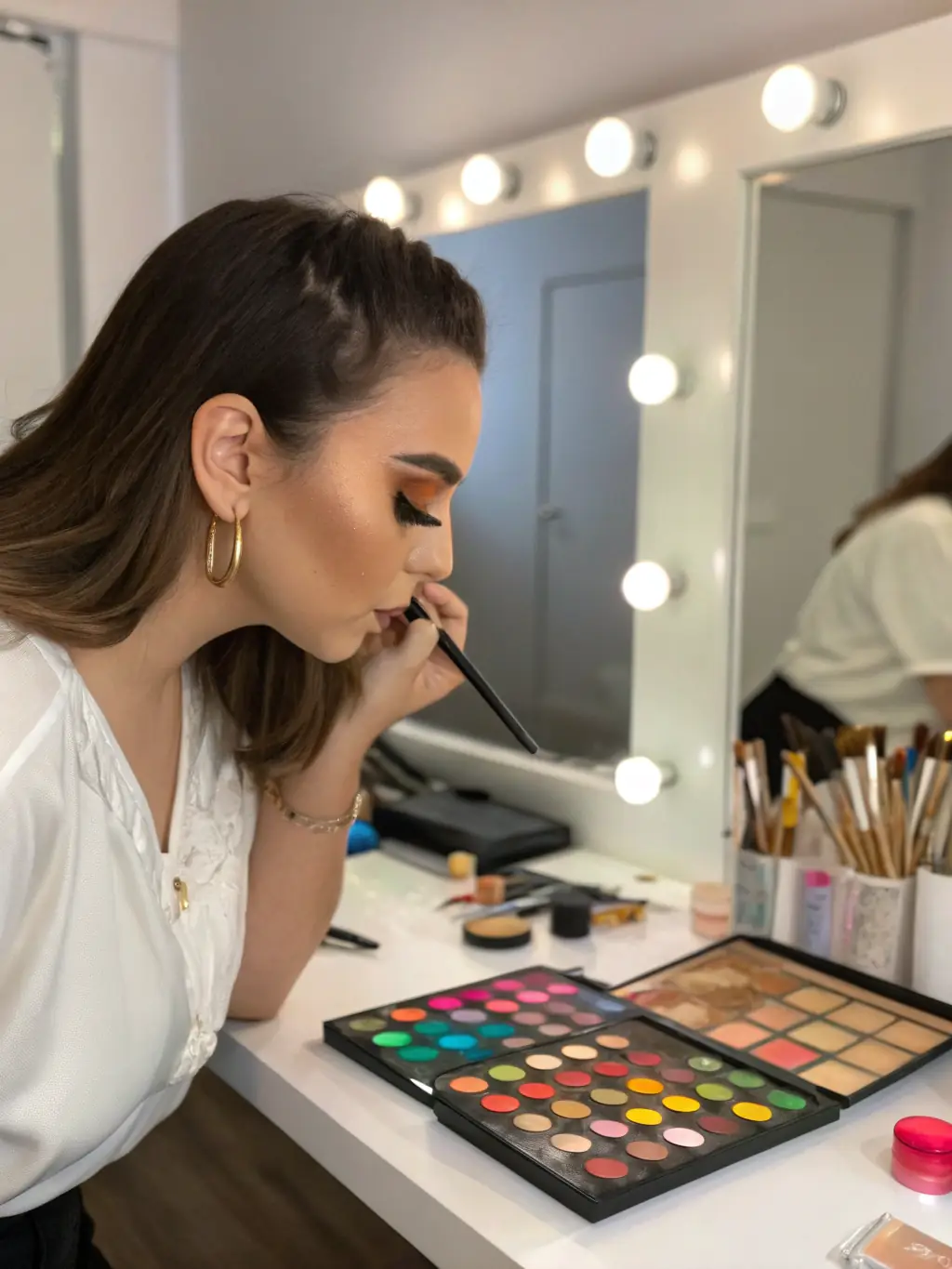 A close-up shot of a person applying makeup, highlighting the details of beauty products and techniques.